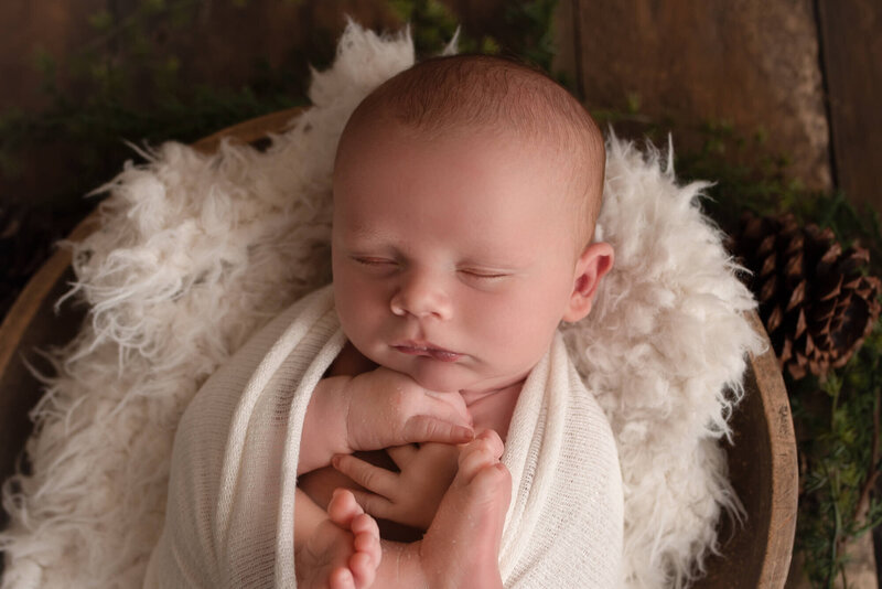 Green Lake Wisconsin Newborn Photographer baby sleeping in prop in studio Christmas set up | Glory Be Photo by Tara Bos