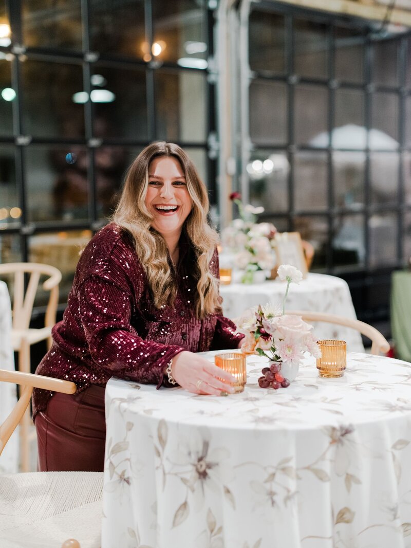 Carissa smiling while lighting a candle for an event