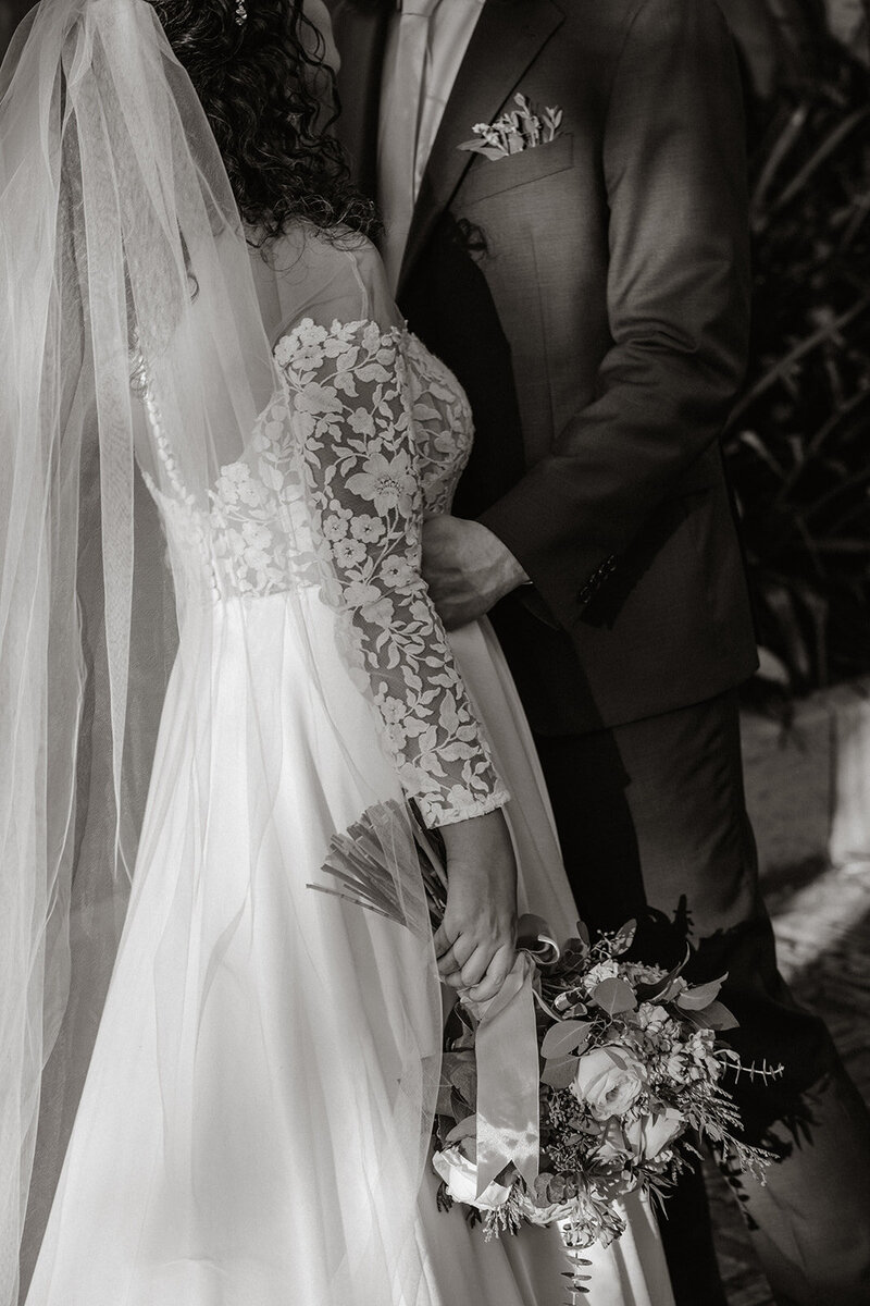 bride and groom holding each other wedding day