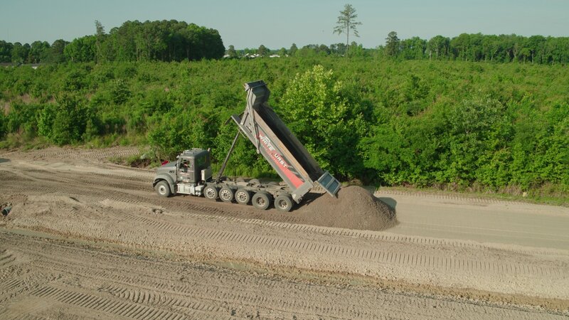 dumptruck dumping dirt on job site