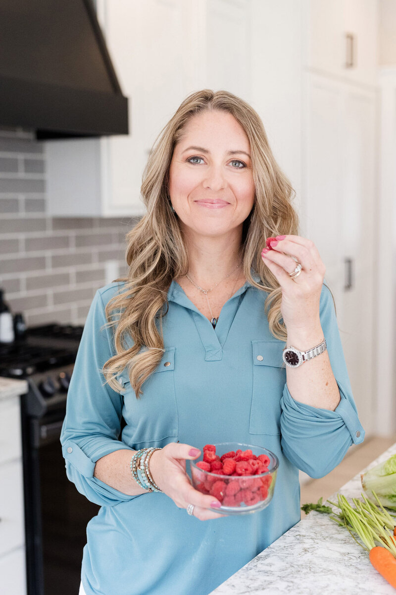 Amy eating a bowl of raspberries
