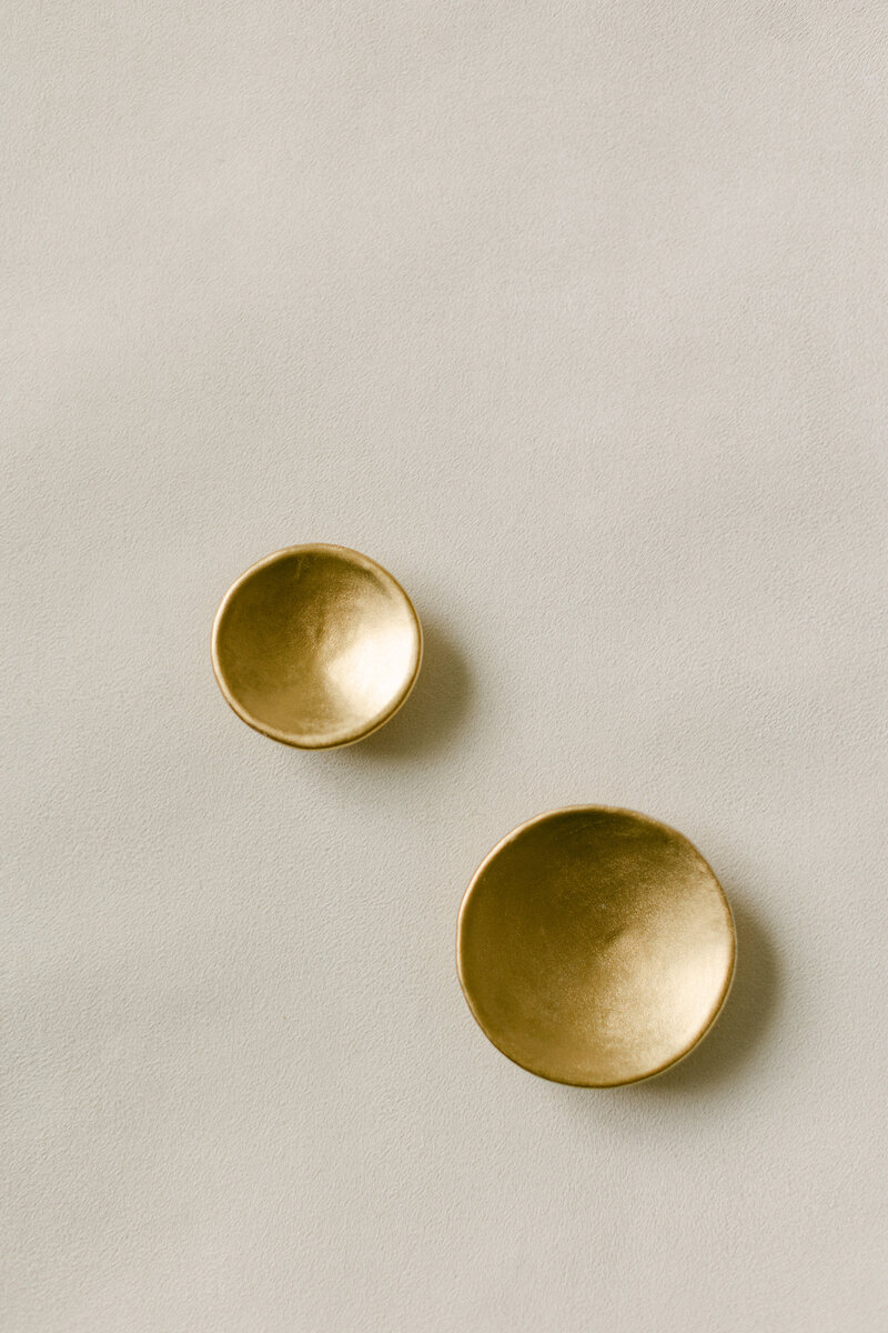 Handmade ceramic dishes used to organize accessories in flat lay photography