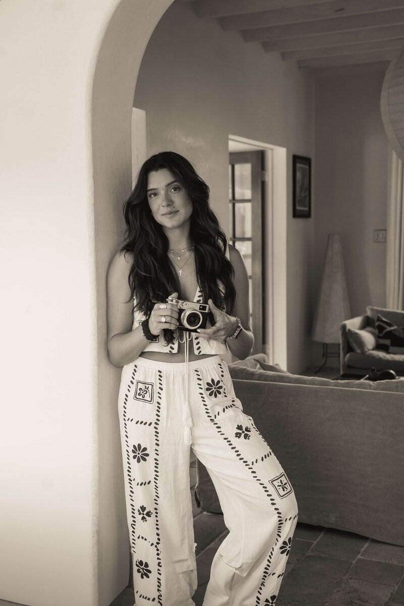 Girl taking photo with film camera