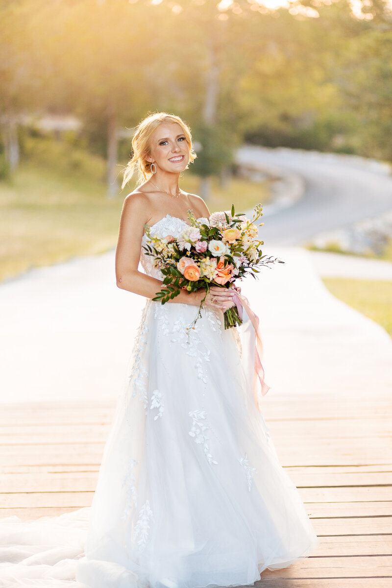 gorgeous bridal portrait on covered bridge smiling at camera