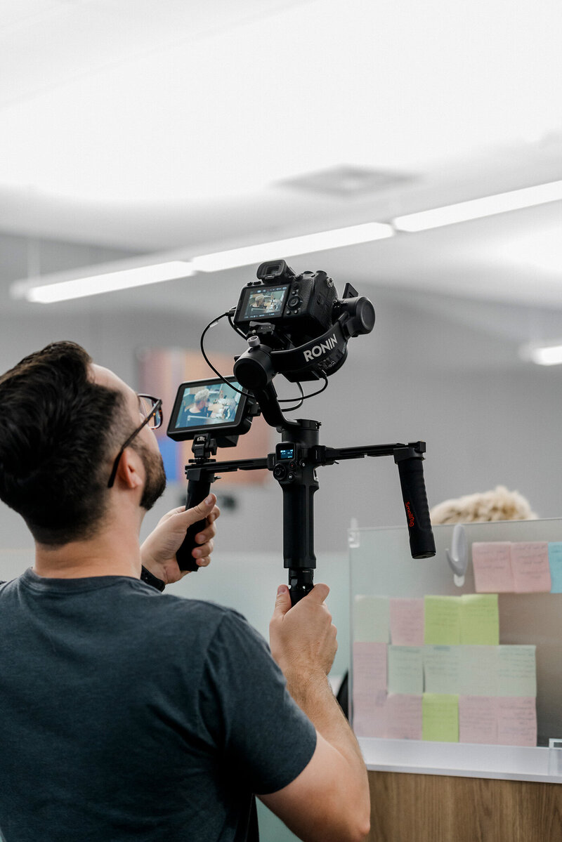 cinematographer chris costello operates a camera gimbal on location