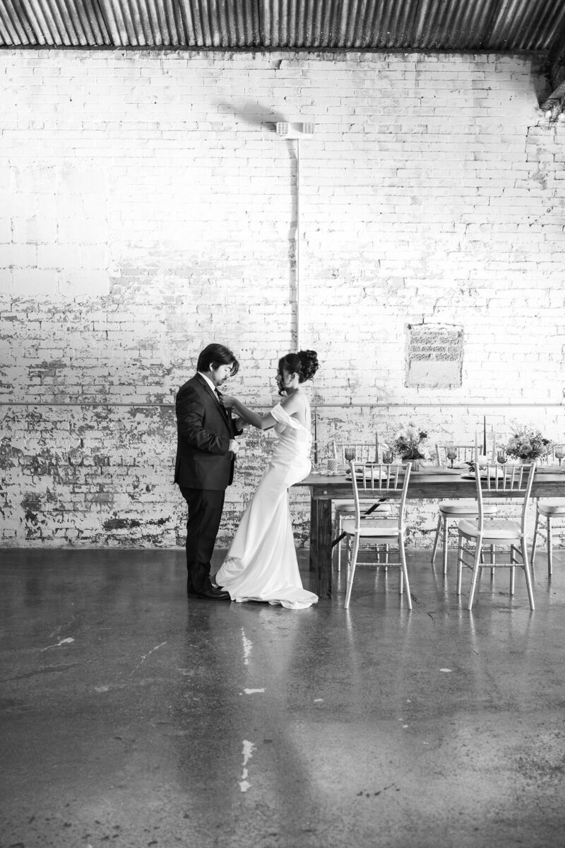 bride and groom getting ready together at The Dealership in Oxford Michigan