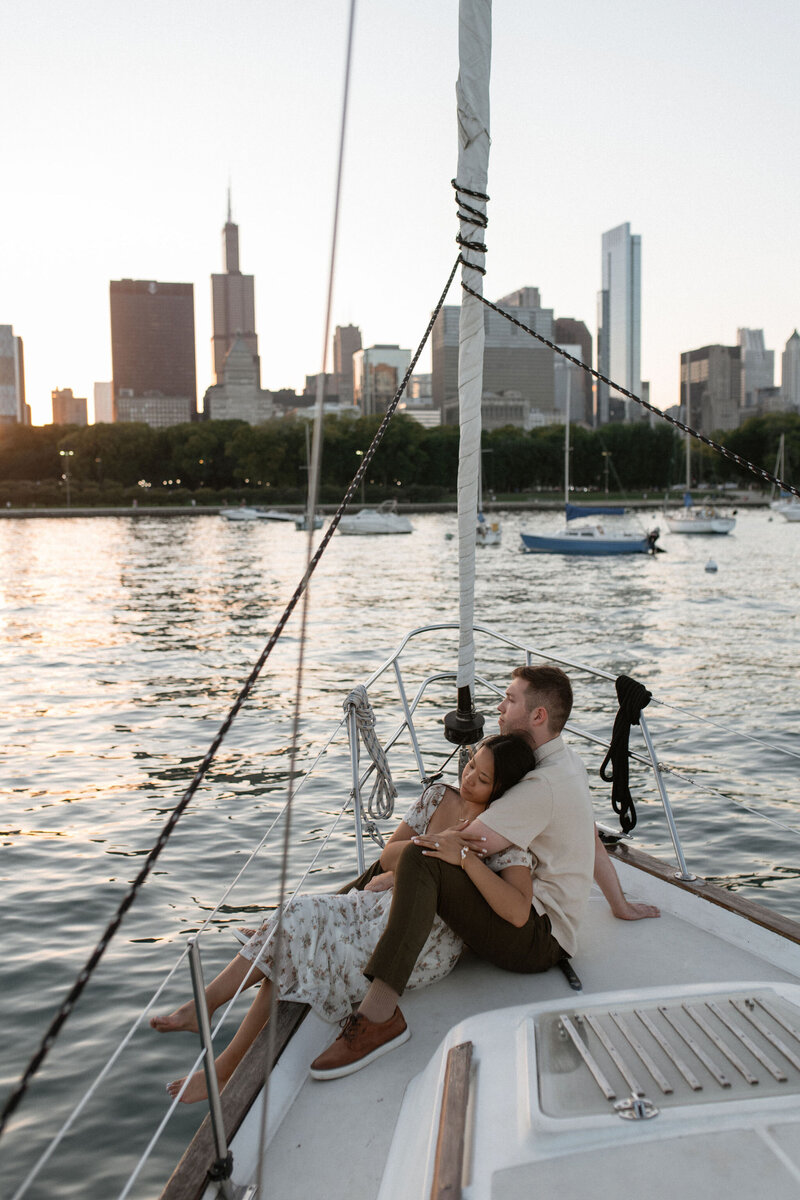 a couple snuggling on a sailboat in chicago