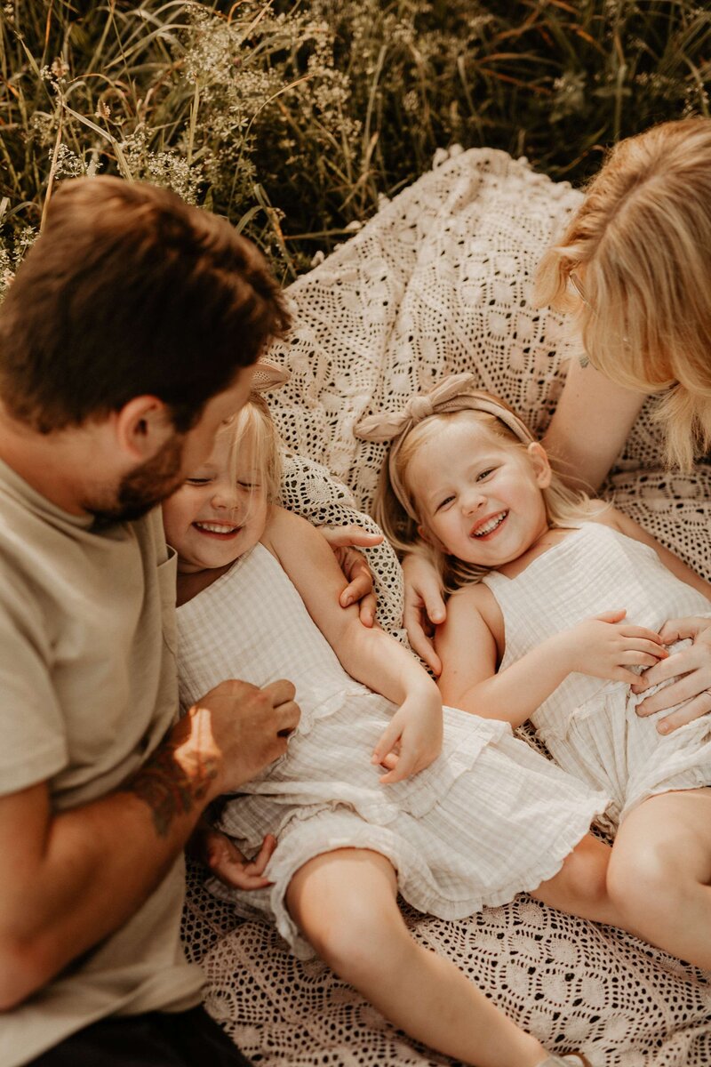 Husband and wife holding smiling baby