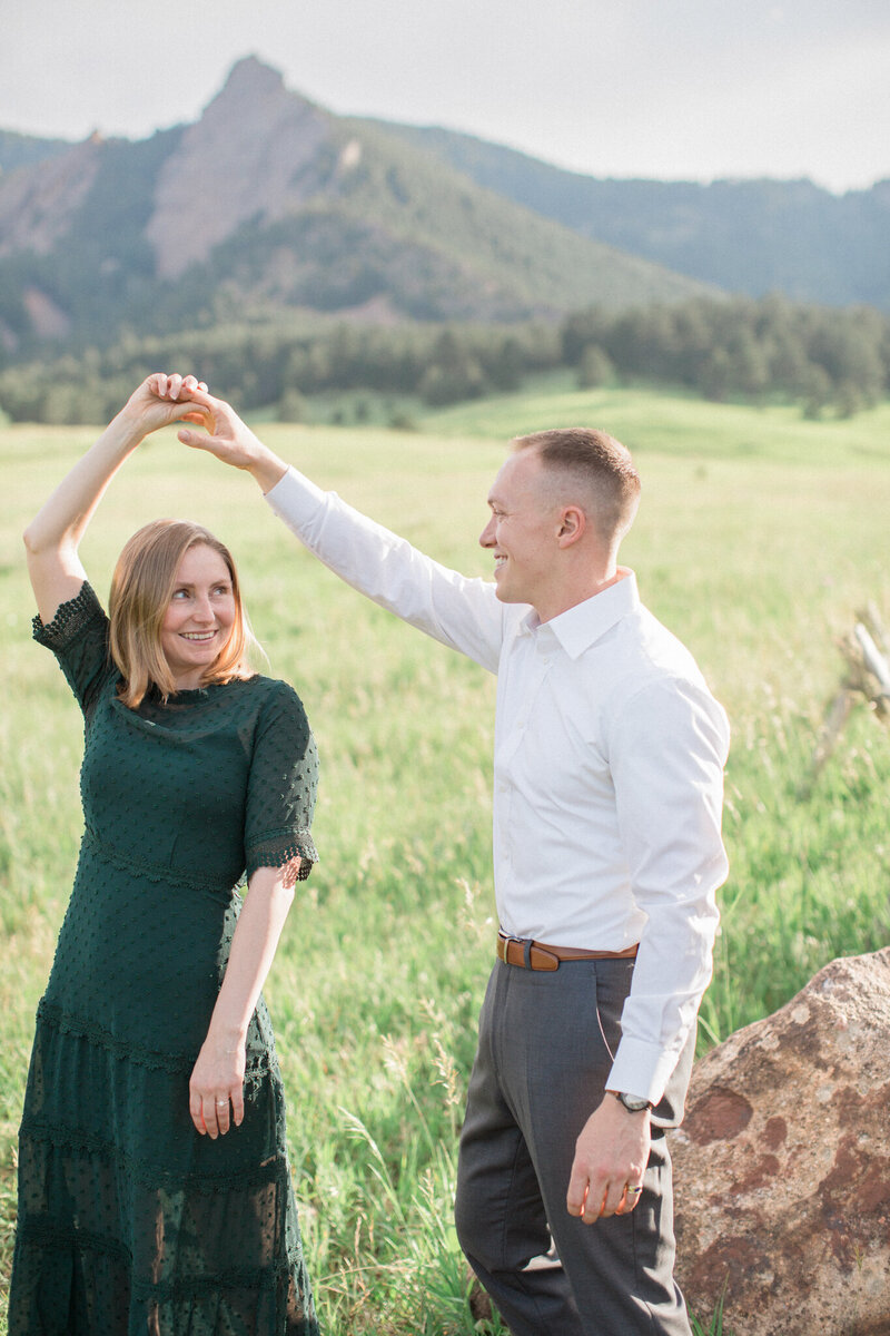 A newly engaged man gives his fiancee a twirl at Chautauqua park in Boulder, Colorado