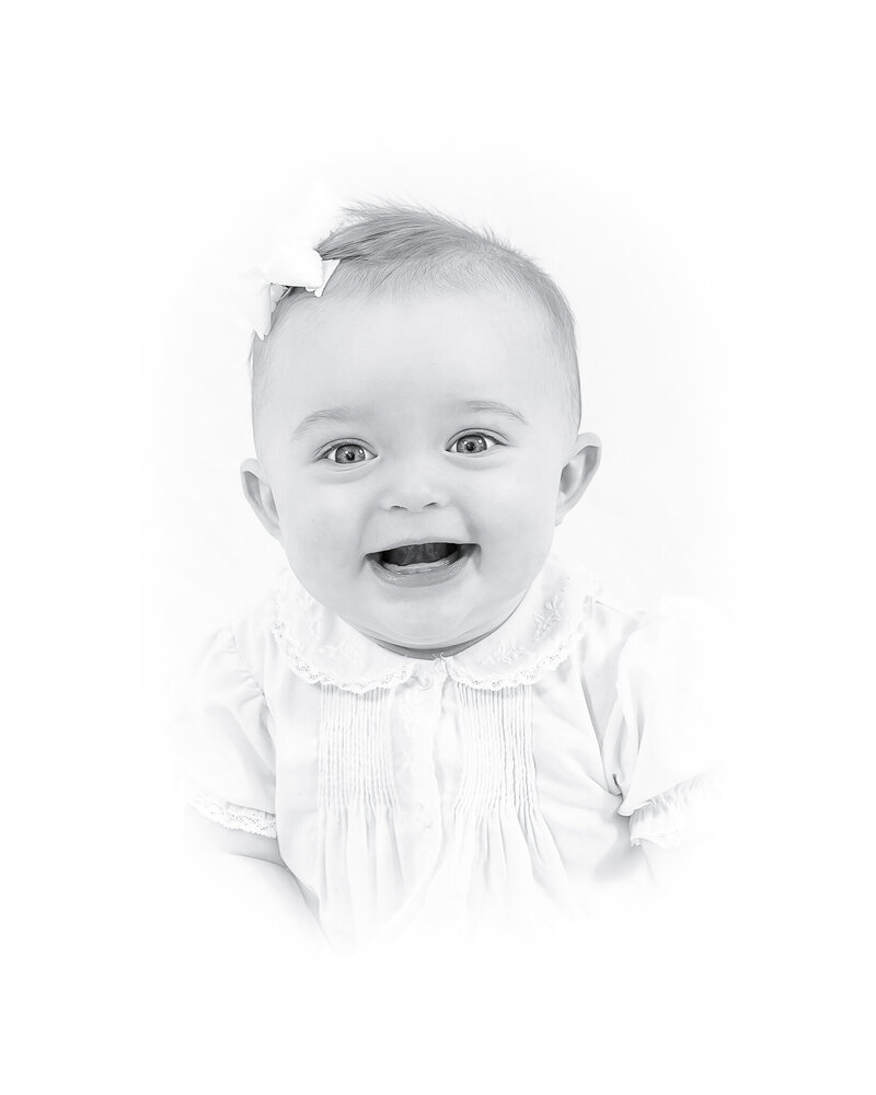 A classic heirloom children's portrait featuring a young toddler with golden hair and bright blue eyes, dressed in a traditional light blue outfit. Timeless children's photography with a soft, painterly background.