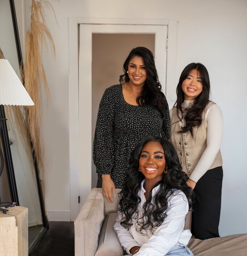 Group photo of Tolu Adepoju, Tonya Ngo, and Nisha Damani at Ashay Therapy, representing a diverse and culturally attuned therapy team in Calgary and virtual sessions across Canada.