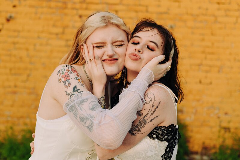 attooed couple sharing a candid moment during their alternative wedding in Springfield, MO, photographed by Chelsea Stanford.