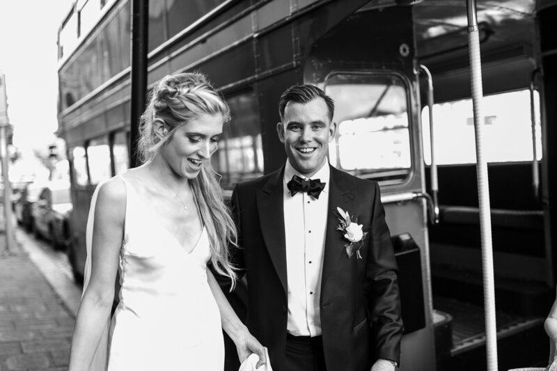 Bride and groom in front of route master bus