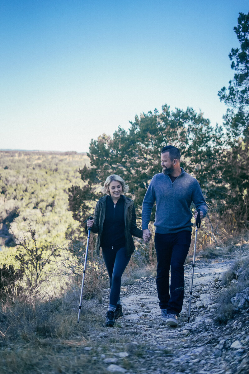 Couple on a hiking trail with hiking sticks