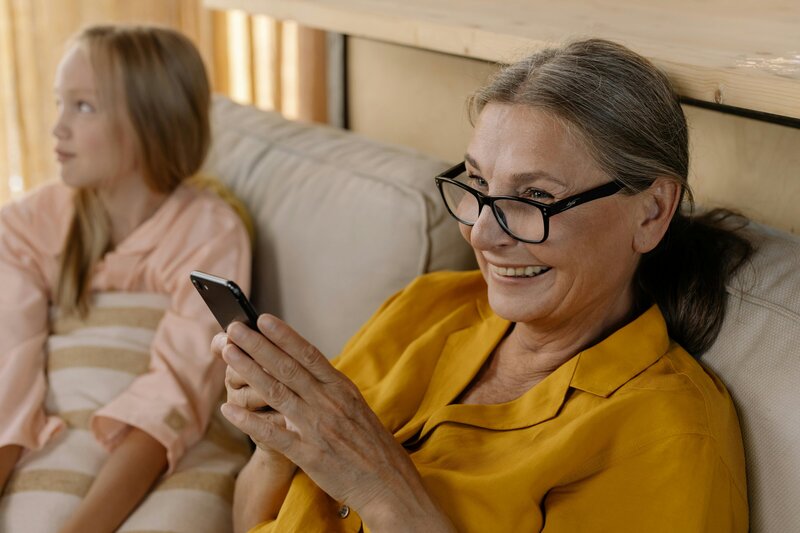 Elderly woman on her phone smiling
