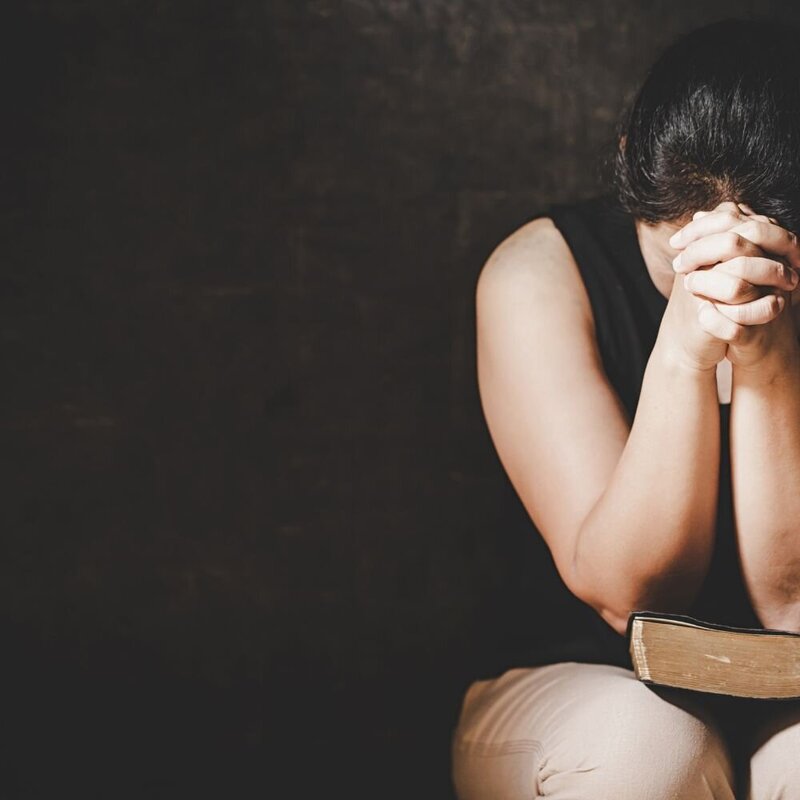 Christian wife fervently praying for her husband after betrayal