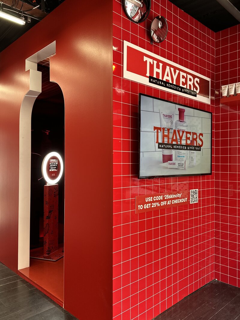 Immersive red photo booth installation branded for Thayers, featuring a sleek setup with digital signage and a MISGIF photo booth experience designed for corporate events and brand activations in Phoenix, Arizona