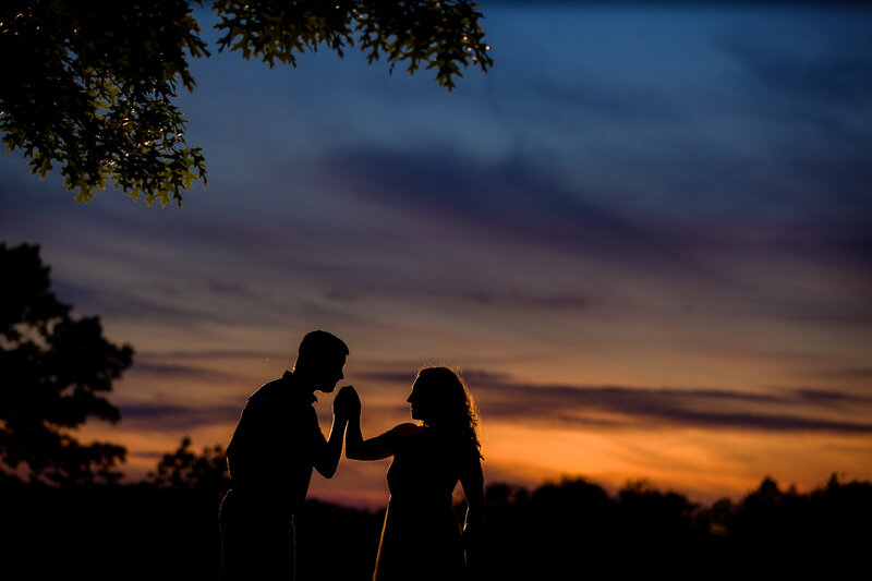 Couple standing together at sunset during their Valley Forge National Historical Park engagement session, enjoying the summer warmth.