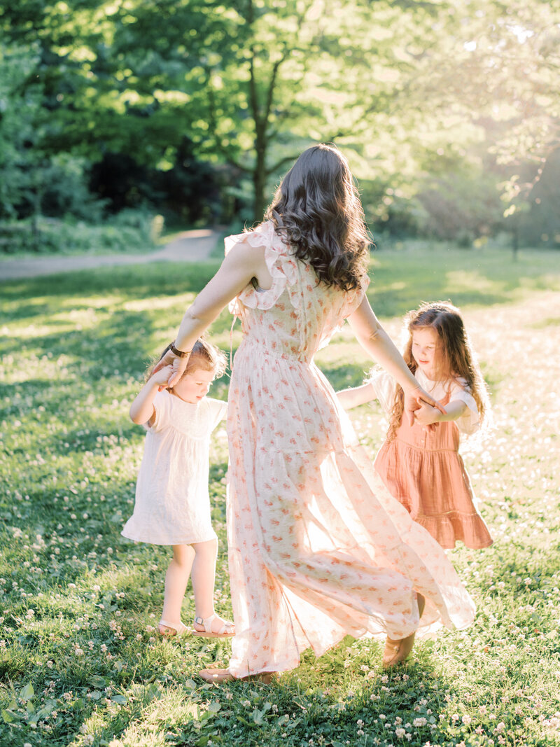 Mother and Daughters dancing in their sunlit yard | Pittsburgh Family Photographer | Anna Laero Photography