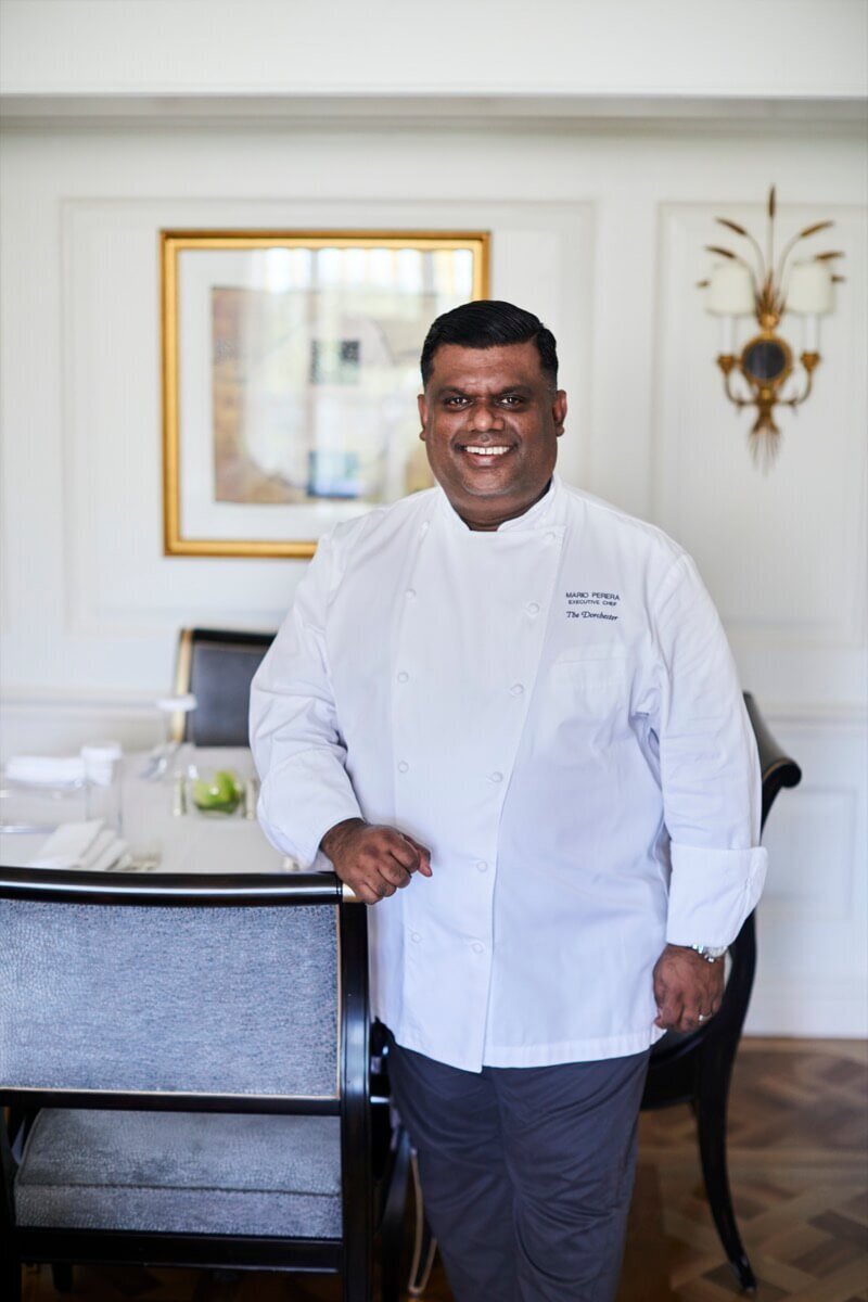 A photo of Chef Mario from The Dorchester leaning against a chair