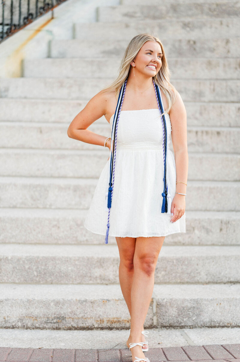 Grad celebrating graduation with cap in the air taken by best college grad photographer in Worcester, MA