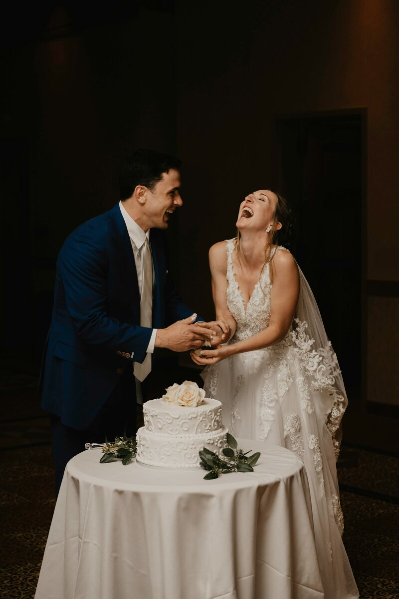 ecstatic couple cutting cake