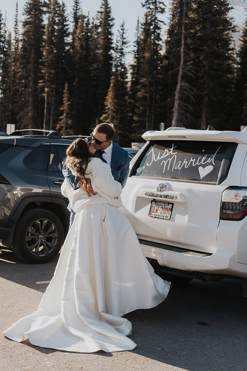 An eloping couple celebrating their newly married status in Banff National Park