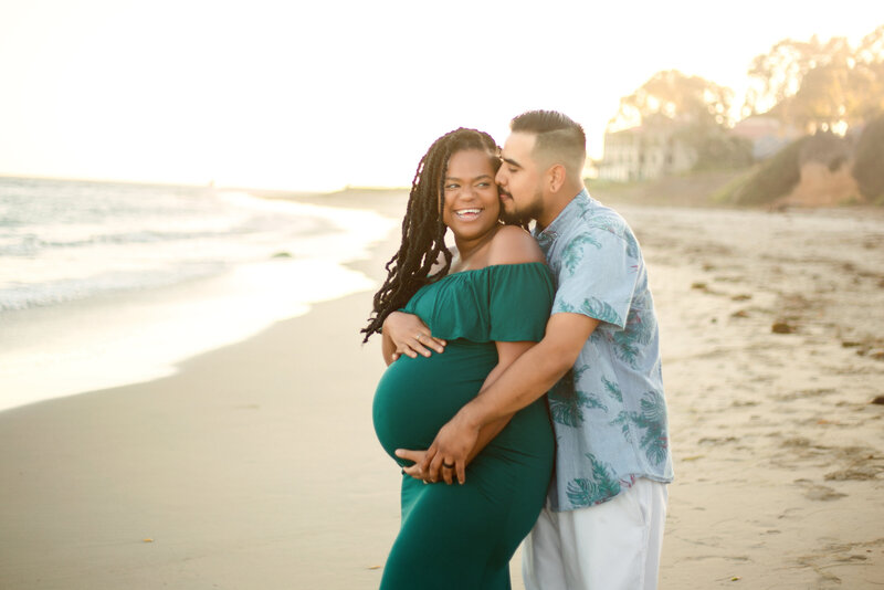 new parents celebrating pregnancy on Los angeles beach