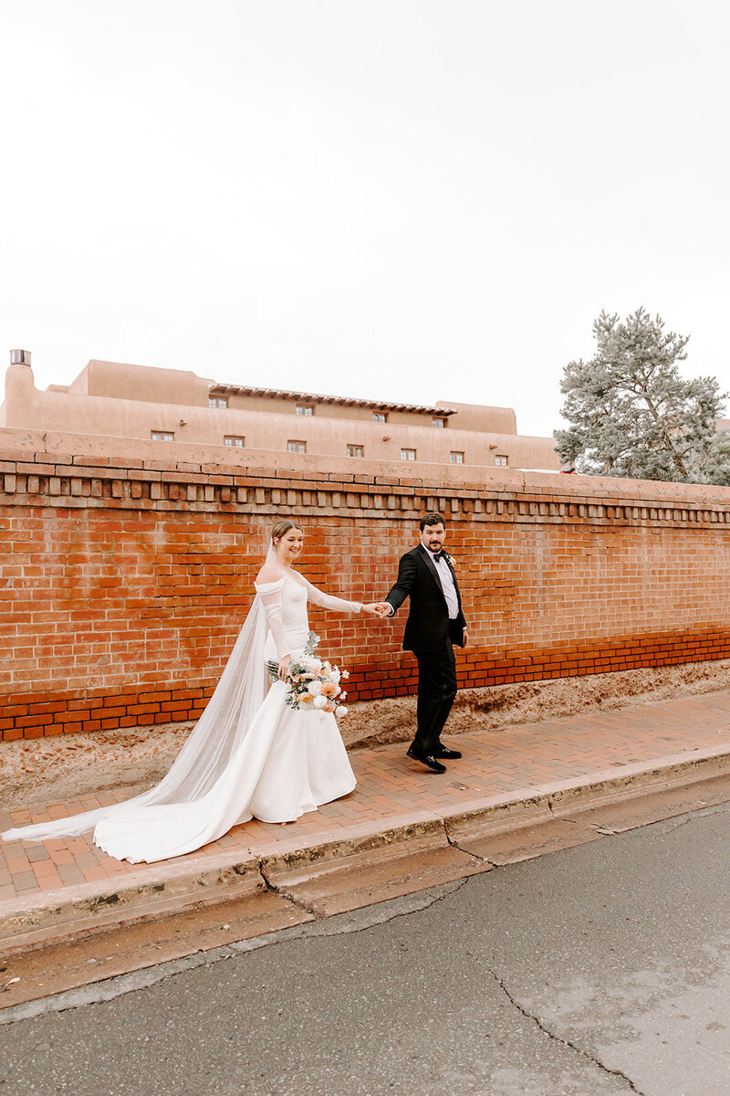 Bride and Groom kissing with cathedral in background