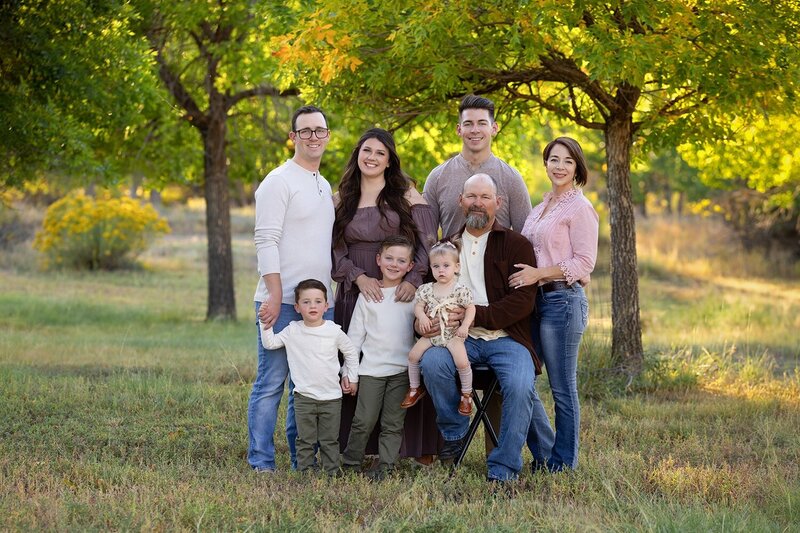 family of six standing together ina wooded area