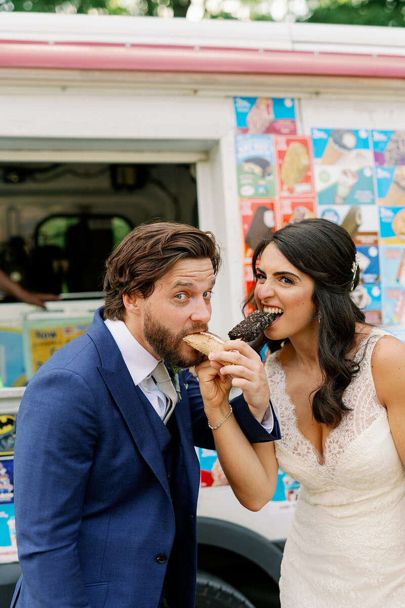 newlyweds stand on sidewalk