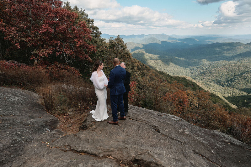 Couple having a wedding ceremony on the side of a mountain
