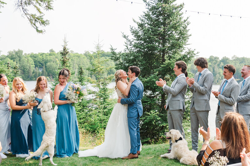 dog jumps during couples first wedding kiss