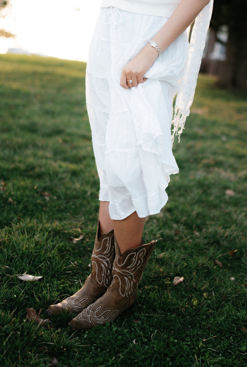 woman in cowboy boots stands at lakeshore park in knoxville tennessee