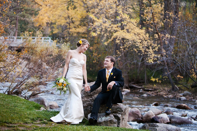 Cute wedding portrait next to Boulder Creek at Wedgewood Weddings in Colorado