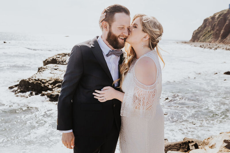 Elopement Photographer, bride kisses groom on the cheek at the beach