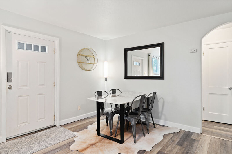 dining table with black chairs and marble top