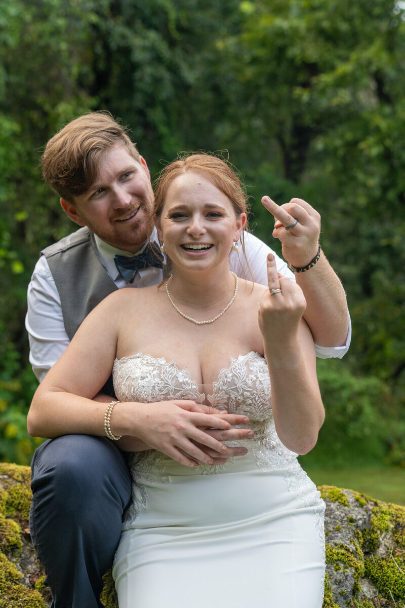 Bride and Groom showing off their new wedding rings.