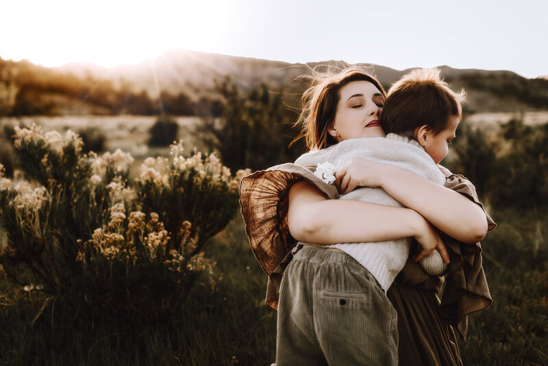 A mother and daughter laugh as they rub noses together in the Gillette, WY sunset at Camplex Park. 