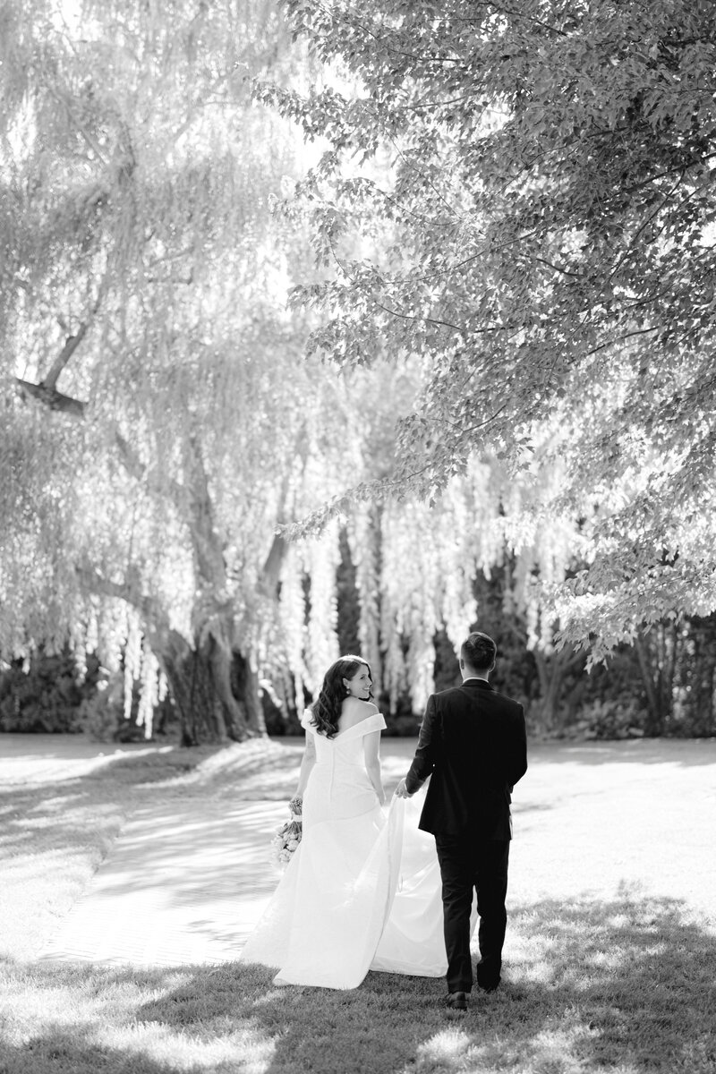 bride and groom walking the grounds at promise garden