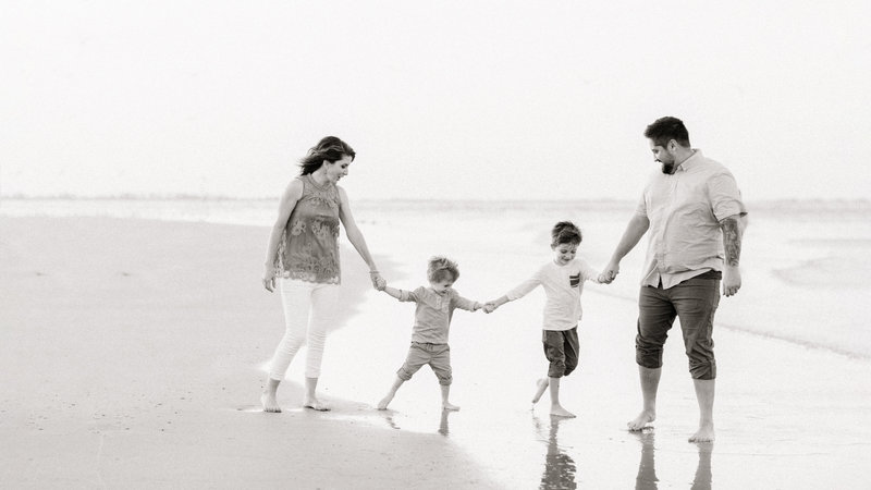 Happy family on the beach during their beach family photos in Hilton Head