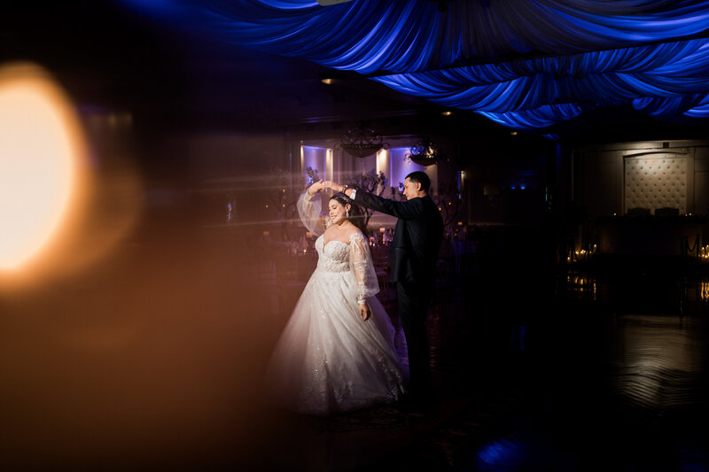 groom twirling bride around the dance floor