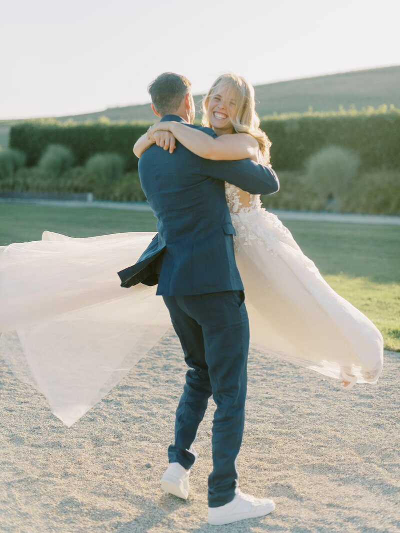 A-bride-and-groom-hugging-in-the-dirt