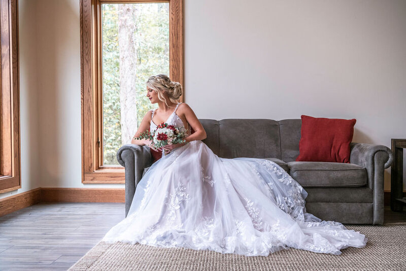Bride and groom smile into the distance resting their foreheads lightly  against one another