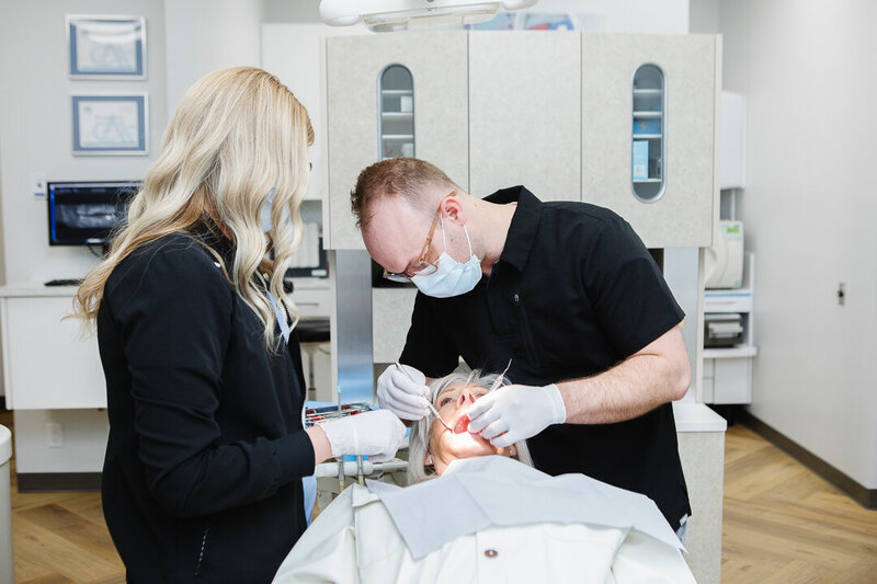 Dr. Tyson Merrill at Peak Prosthodontics restoring strength and beauty to a patient’s smile with a dental crown in Lethbridge, Alberta.