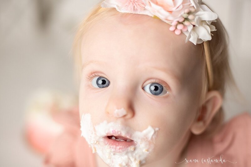 baby girl with frosting on her face