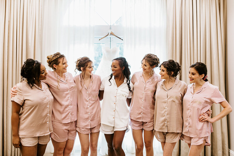 bride and her bridesmaids posing while getting ready