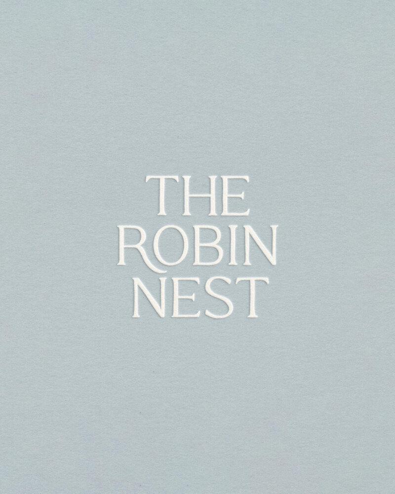 Elegant serif wordmark on muted blue background designed to attract thoughtful, wellness-focused creative entrepreneurs.