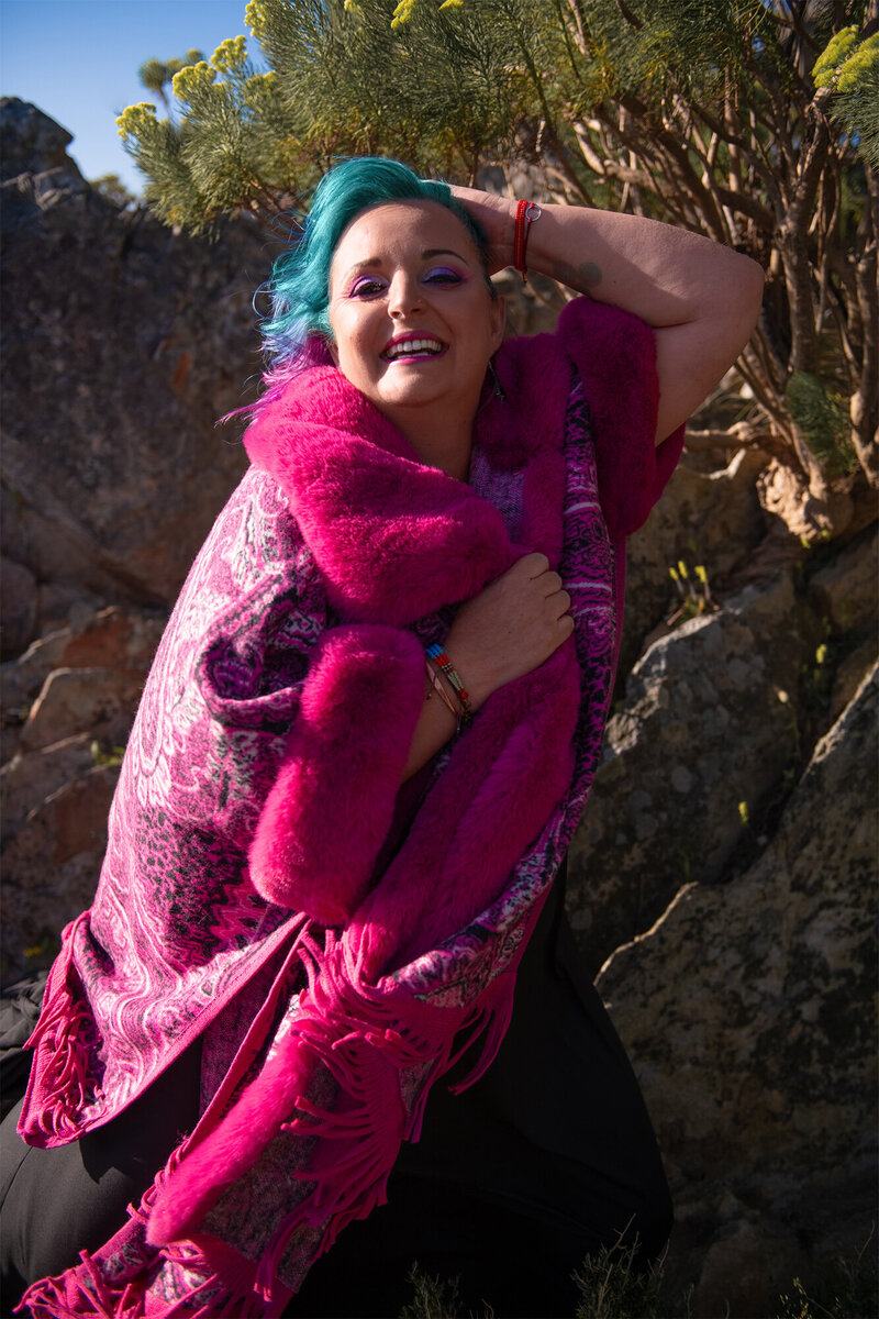 Yolandi Boshoff on a mountain in a pink jacket, offering radical support to claim your Soul Authority.