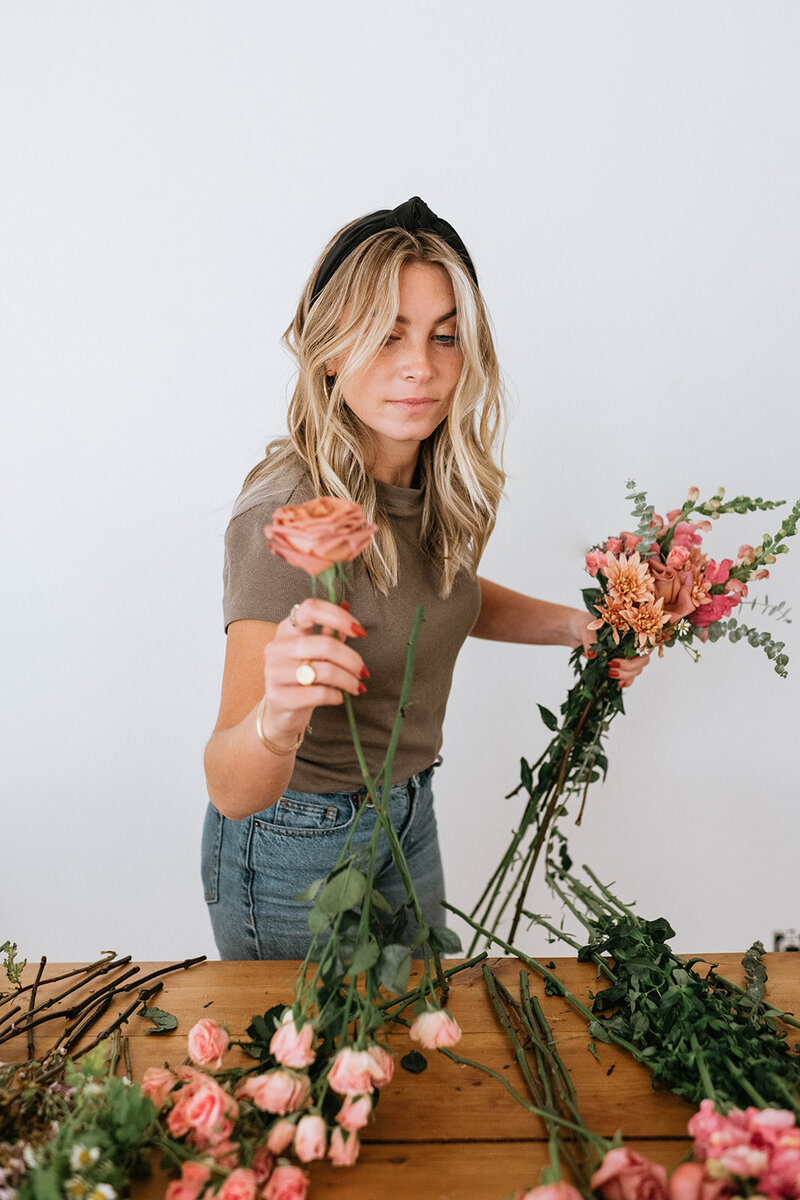 Florist arranging flower stems